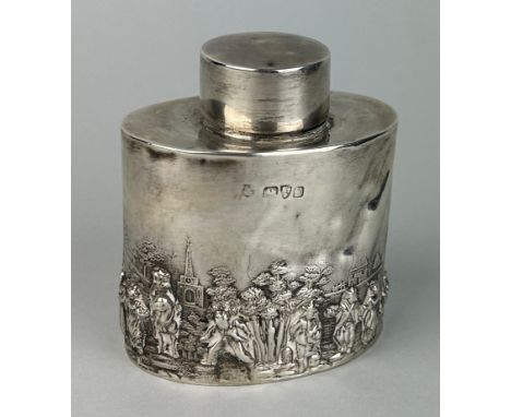 AN ENGLISH SILVER TEA CADDY DECORATED WITH A RURAL VILLAGE FETE SCENE AND FIGURES DANCING, Weight 110gms. Dents to side. 