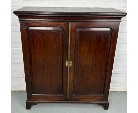 A 19TH CENTURY CABINET,Two doors with bracket feet, brass escutcheons.120cm x 105cm x 34cm 
