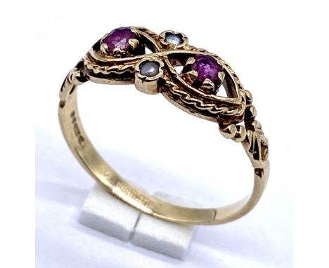A turn of the century 9ct gold ruby and seed pearls ring, size O 1/2