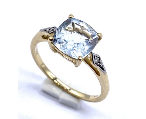 A 10K gold cushion cut aquamarine ring with diamonds to shoulders, size N 1/2