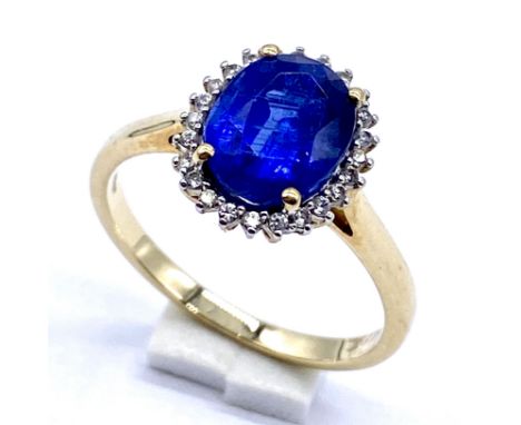 A 10K/375 gold blue and white topaz dress ring, Size N 1/2, 2.6 grams total.