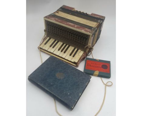 A vintage Antonia Silvagni accordion, boxed set of draughts and a book safe.