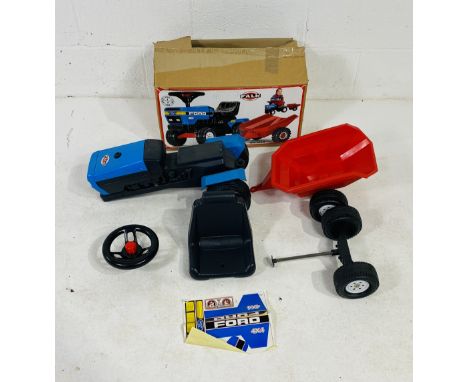 A boxed child's Falk ride on Ford tractor with matching trailer 