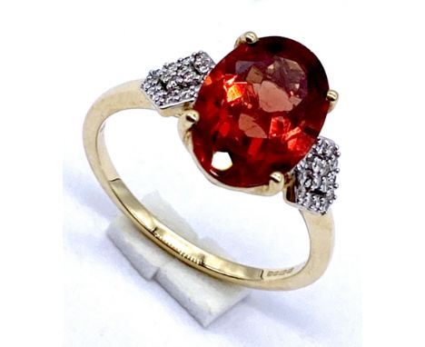 A 18K gold orange quartz dress ring set with diamonds to the shoulders, Size N 1/2, 3.8 grams total.