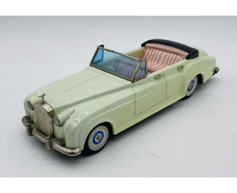 A Bandai (Japanese) tinplate early 1960's friction powered Rolls Royce Silver Cloud 4 door open top saloon car with detailed 