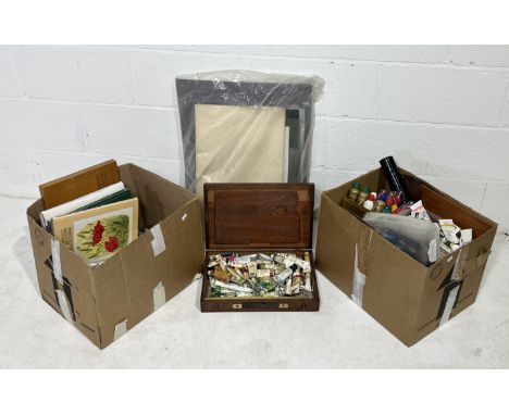 A large collection of art supplies including oil paints, tools, brushes, pastels, art books, paper etc.