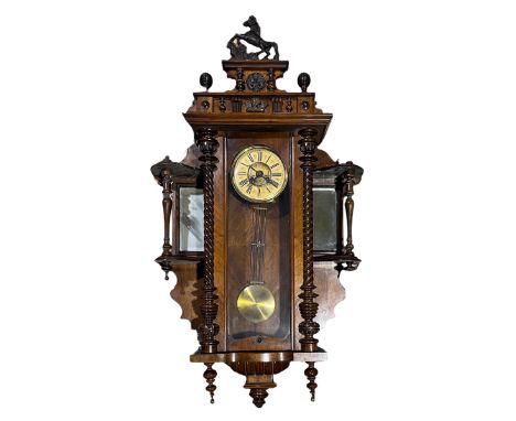 A large turn of the century Vienna style mahogany cased wall clock (possibly German) with removable mirror backed shelves to 