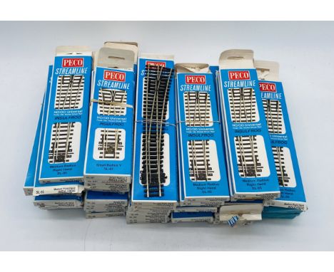 A collection of model railway Peco Streamline OO gauge silver rail points including medium radius right hand (SL-95) & left h