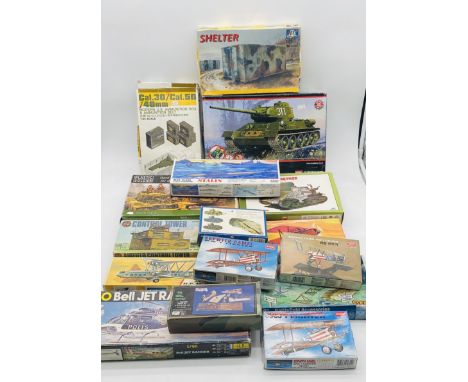 A collection of various boxed plastic model kits relating mainly to the military including tanks, ammunition box, planes, con