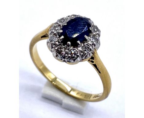 An 18ct gold and platinum sapphire and diamond cluster ring, size L 1/2, weight 2.9g