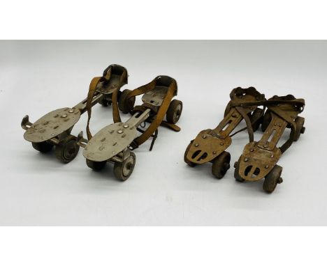 Two pairs of vintage roller skates, one pair marked with AW