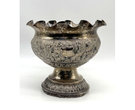 An Indian silver bowl with fluted rim and repousse decoration depicting a village scene, engraved " With best compliments fro