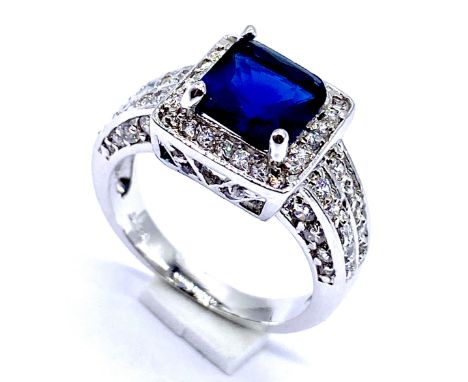 A 14K white gold dress ring set with blue and white coloured stones, Size N, 4.9 grams total.