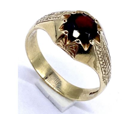 A gentleman's 9ct gold ring set with a garnet, total weight 4.2g, size V