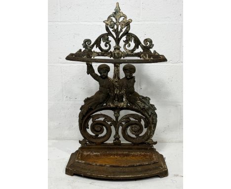 A cast iron stick stand with twin cherub and scrolled decoration - height 77cm