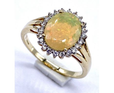 A 10K/375 gold Ethiopian opal surrounded with white coloured stones, size N 2.6 grams in total.