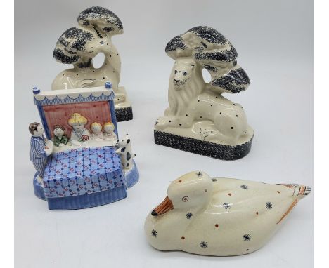 A pair of Rye pottery flatbacks, a lion and a unicorn,a duck and a fairing group. 