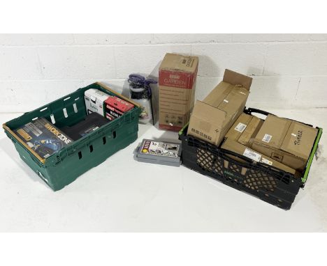 A collection of various boxed tools including a planer, battery charger, trimmer, vice etc.