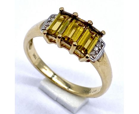 A 10K gold ring set with emerald cut citrines with diamond highlights, size N