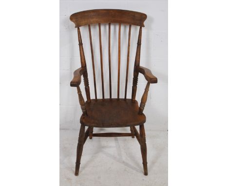 An antique elm Windsor stick-back chair, marked 'JG' to back of seat
