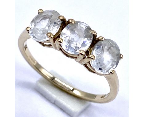 A 10K/375 gold dress ring set with three white topaz, Size N1/2, 2.1 grams total.