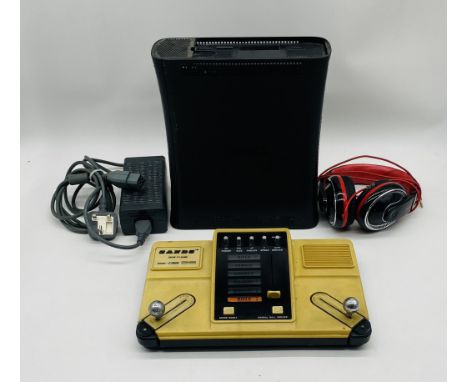 An unboxed Microsoft Xbox 360 computer console with power cable (untested), along with Sands Colour TV Game (no cables) and a