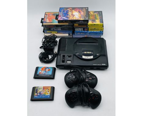 An unboxed 16-Bit Sega Mega Drive console with a selection of nine games, two controllers and cables, along with a vintage Bi