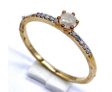 A 10K ring with diamond solitaire and diamonds to shoulders, size N 1/2