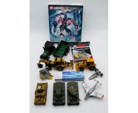 A mixed collection of various toys including Tonka tractor and trailer, two toy diggers, boxed Lego Hero Factory (contents un