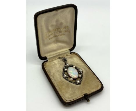 A turn of the century Liberty & Co. opal, diamond and seed pearl pendant in original leather retail box, the opal measuring a