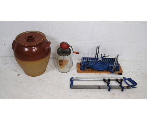 A large stoneware lidded pot along with a vintage Blow Butter Churn and a TUV Rheinland mitre saw