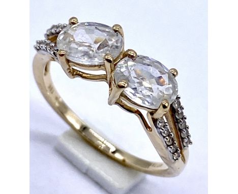 A 10K/375 gold dress ring set with two white topaz, Size N1/2, 2.5 grams total