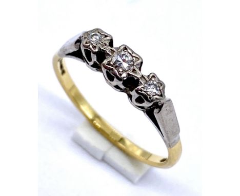 An 18ct gold diamond three stone ring with illusion setting, size P, weight 2.8g