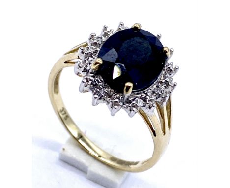 A sapphire and diamond cluster ring set in 9ct gold, size N