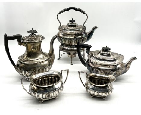 A Walker & Hall hallmarked silver four piece tea set comprising of coffee pot, teapot, sugar bowl and milk jug along with a m