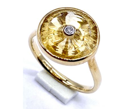 10K/375 gold Torus ring with citrine set with single diamond, Size N1/2, 3.4 grams total. 