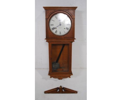 An oak cased American wall clock marked 'Seth Thomas' - one part loose but present - with key