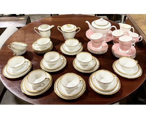A Limoges Cenpor gilt patterned part dinner service along with a pink Colclough part tea service