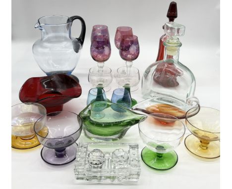 A collection of various coloured glass including large pitcher, dessert bowls, decanter, wine glasses etc. 