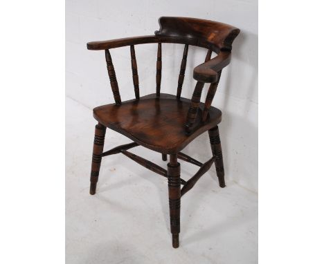 An antique elm captain's chair with turned supports, marked 'G R V' and 'JS'