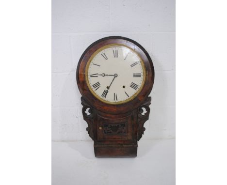 An antique wall hanging clock, with carved detailing