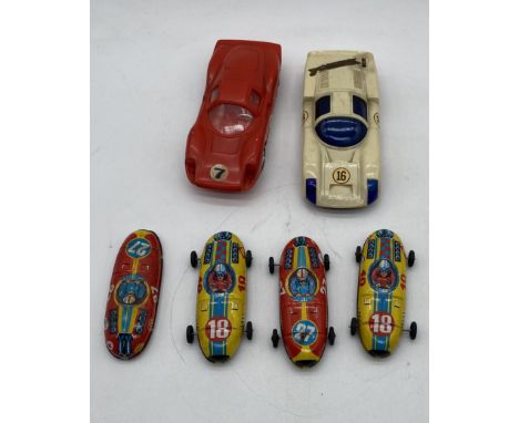 Four vintage tinplate racing cars (2 x Shell, 2 x Esso - one missing wheels), along with two other two cars including Kawada 