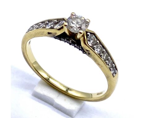 An 18ct gold ring set with central diamond and graduating diamonds to shoulders, size N 1/2