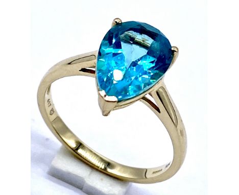 A 10K/375 gold pear cut blue topaz ring, Size N1/2, 2.5 grams total.