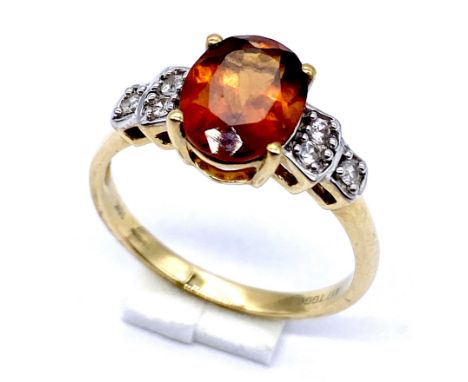 A 10K/375 gold dress ring set with red and white quartz stones, size N, 2.5 grams total.