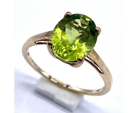 A 10K/375 gold solitaire peridot oval cut ring, Size N, 1.7 grams total.
