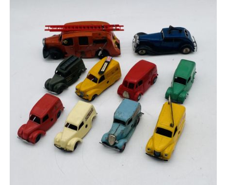 A collection of vintage Tri-ang clockwork vehicles including a fire engine, police car and eight advertising vans (Kodak, Roy