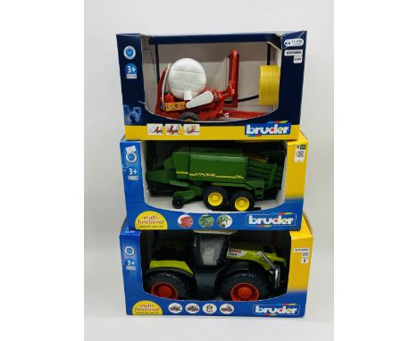 Three boxed Bruder multi-functional toy farm vehicles including a Claas Xerion 5000 tractor, John Deere Bailer & RoTo Bale Wr