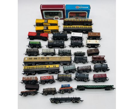 A collection of model railway OO gauge passenger coaches and rolling stock including coal wagons, brake vans, goods wagons, b