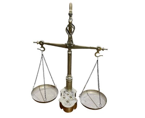 A set of brass scales with four inset weights